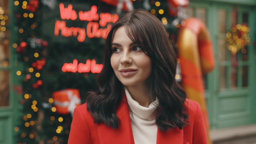 Portrait of the Charming Woman Standing in Festively Street. New Year. Lovely Lady Outside. Cute Girl Looking at the Camera Outdoors on the Decorated City Background. People and Holidays Concept | Shutterstock HD Video #1111992207