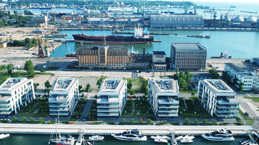 Scenic Marina With Boats And City Skyline In Gdynia, Poland - aerial shot