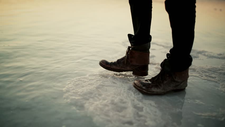 Walking with dirty old leather boots over salt into the Dead Sea, Israel | Shutterstock HD Video #1111993191