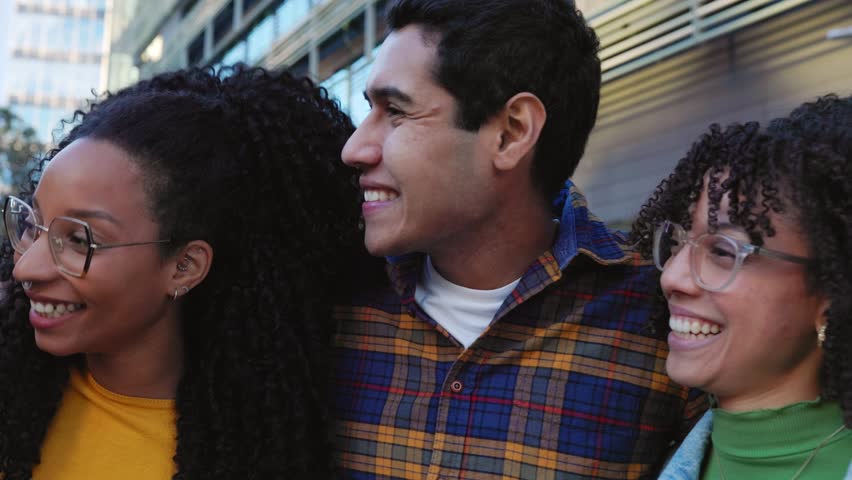 United millennial group of multiracial friends hugging each other laughing together outdoors. Playful diverse college student having fun, hanging out and enjoying time in the street. | Shutterstock HD Video #1111993819