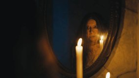 Old woman witch performing occult ritual using mirror, contacting evil spirits - Powered by Shutterstock - Get 15% off with code: PIKWIZARD15