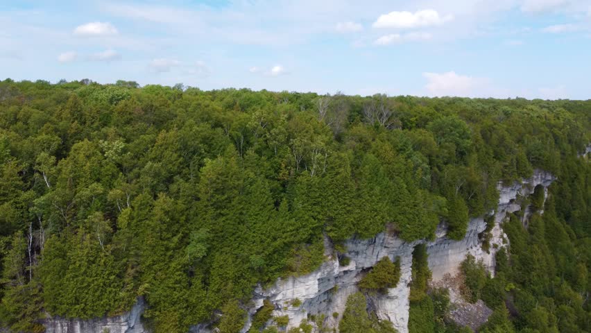 Drone tilting slowly to show the vast expanse of the Georgian Bay boreal forest and coastline in Ontario, Canada.