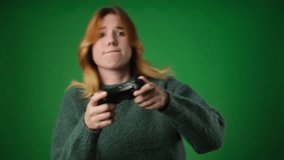 Young Caucasian Woman with Gamepad Winning in Video Game on Green Background
