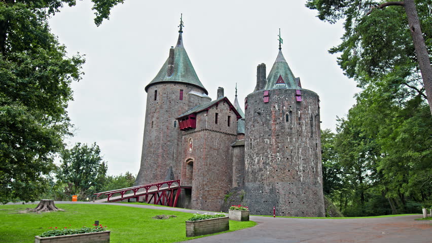 Red Castell Coch with great towers and conical roofs in Cardiff, Wales. Castle built in the gothic-revival style surrounded by ancient beech woods of Fforest Fawr like a vision from a fairy tale
