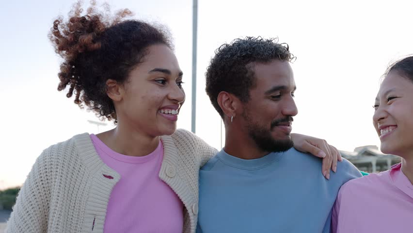 Diverse group of happy young people having fun together outdoors. Millennial generation friends from different cultures hugging each other while laughing and bonding at city street. | Shutterstock HD Video #1112006333