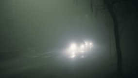 Traffic on foggy misty night road illuminated by street lights - Powered by Shutterstock - Get 15% off with code: PIKWIZARD15