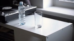 person holds a bottle and pour water in the glass - Powered by Shutterstock - Get 15% off with code: PIKWIZARD15