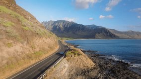Blue convertible car driving on scenic road by West coast on Oahu island. Aerial view sport car with tourist. Road trip, summer adventure. Beautiful nature of Hawaii tropical island in Pacific ocean - Powered by Shutterstock - Get 15% off with code: PIKWIZARD15