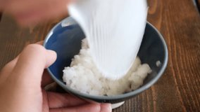 A video of wrapping fresh sujiko in freshly cooked white rice.