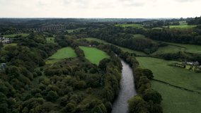 Top cinematic aerial view to the Old Welsh Pontcysyllte Aqueduct waterway aerial view rural Autumn woodlands valley. United Kingdom Aerial