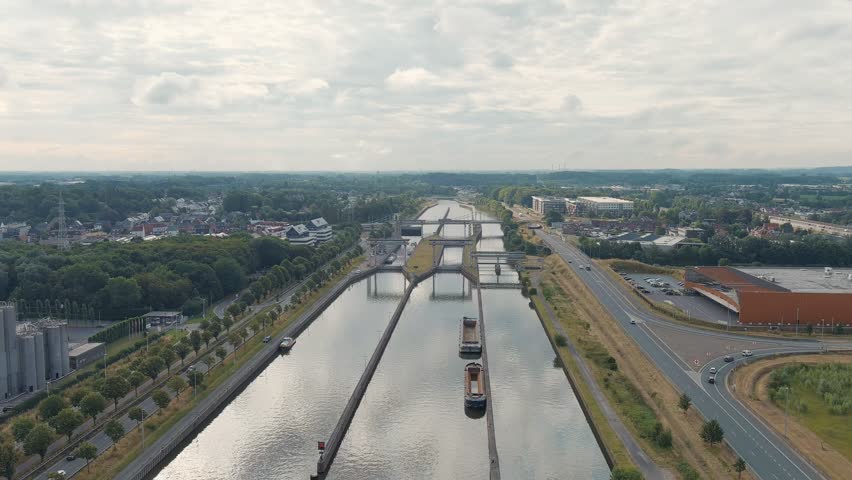 Ghent, Belgium. Ringvaart in Ghent - water channel. Sluis Merebeke - landmark, gateway to the Ringvaart Ghent canal in the town of Merebeke, Aerial View