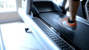 4K Close up on feet of unrecognizable woman working out on running machine Slow motion background exercise