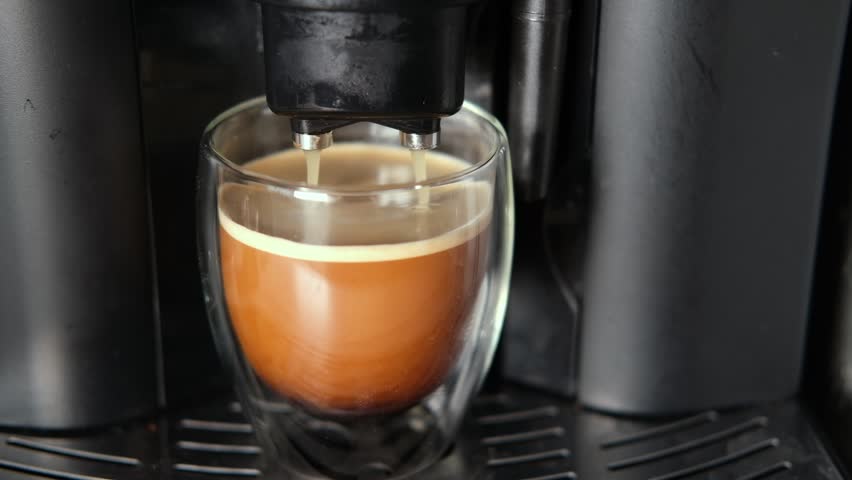 Espresso Pouring from Coffee Machine into Transparent Double Wall Glass Cup. Preparing Fresh Black Americano. Morning Coffee Brewing Preparation. Professional Electric Automatic Kitchen Coffee-Maker. | Shutterstock HD Video #1112027193