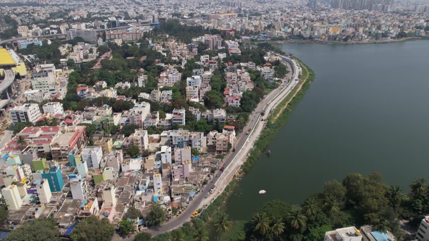 Aerial footage of Madiwala lake is one of the biggest lakes in Bangalore, India, spread over an area of 114.3 hectare. BTM lake Bridge. Vechiles moving with less frequency in the afternoon. Royalty-Free Stock Footage #1112030341