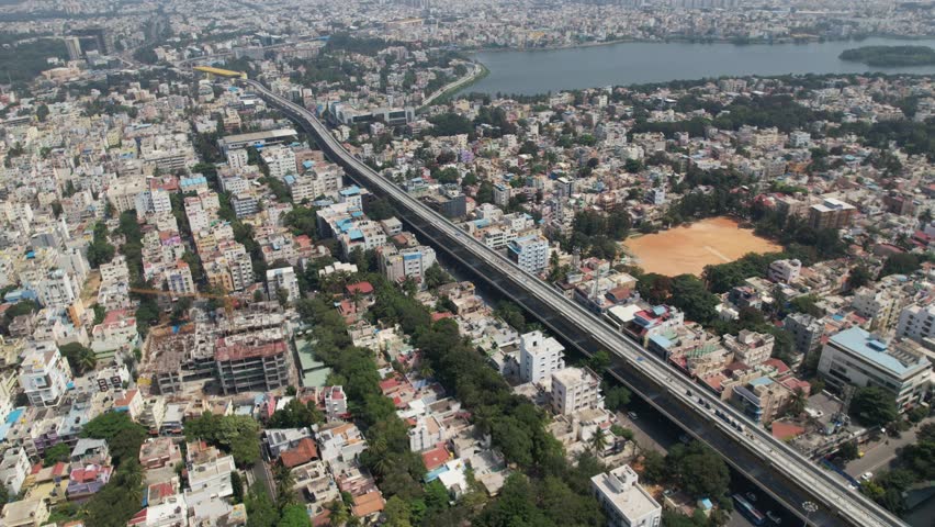 Aerial view of Bengaluru (also called Bangalore) is the capital of India's southern Karnataka state. The center of India's high-tech industry, Metro rail track and Hosur highway road. Madiwala Lake. Royalty-Free Stock Footage #1112030343