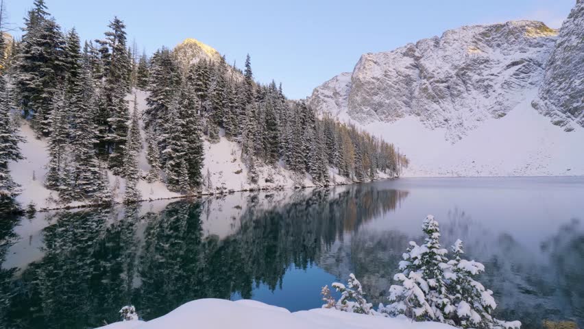 Upper Grassi Lakes in winter season. The reflection of the lake surface like a mirror. Canmore, Alberta, Canada Royalty-Free Stock Footage #1112034663