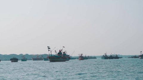 View of boats in Arabian sea at Okha port, Gujarat, India. Concept of transportation in sea. Passenger boat during holidays. Fishing boats at the port with Indian flag on top of them. Stockvideo