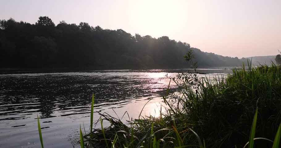 The river during the dawn in autumn , the waves on the river during the sunrise of the sun in the autumn season