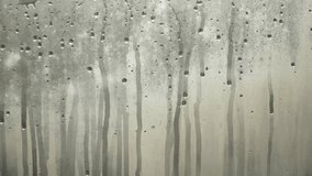 Background video of water drops flowing down foggy cold window during day. Condensation and high humidity in winter on non-energy efficient glass. Melting during change of season. - Powered by Shutterstock - Get 15% off with code: PIKWIZARD15