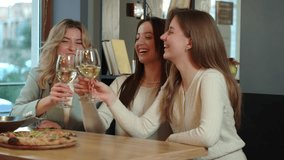 Cheerful young friends drinking wine in restaurant - Powered by Shutterstock - Get 15% off with code: PIKWIZARD15