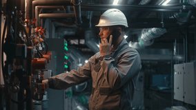 Male heavy industry worker wearing safety uniform, protective glasses and hard hat inspects pipeline system, talks by phone. Engineer maintains modern manufacturing factory or industrial facility. - Powered by Shutterstock - Get 15% off with code: PIKWIZARD15
