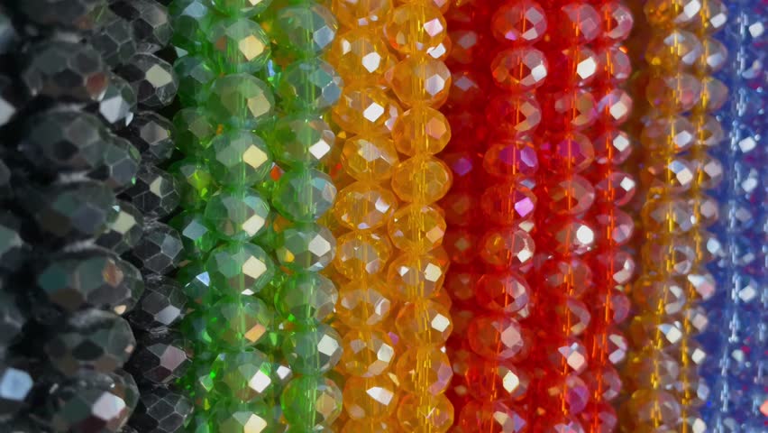 Long strands of small, colorful beads for bracelets, necklaces and decorating bags, clothing or other decorations. Beads of various colors for accessories are sewn on cloth bags or bracelets for beaut