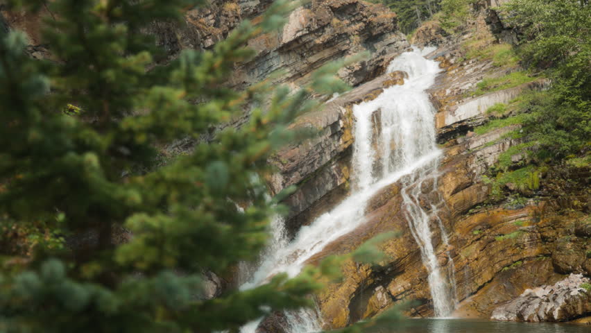 Cameron Falls waterfall streaming down the rocks. Slow motion.