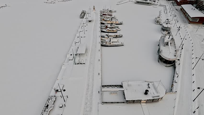 Winter flight over the frozen harbour in Lahti. Historical center.