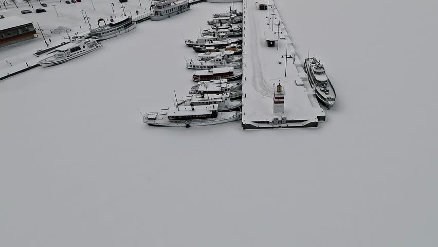 Winter flight over the frozen harbour in Lahti. Historical center.