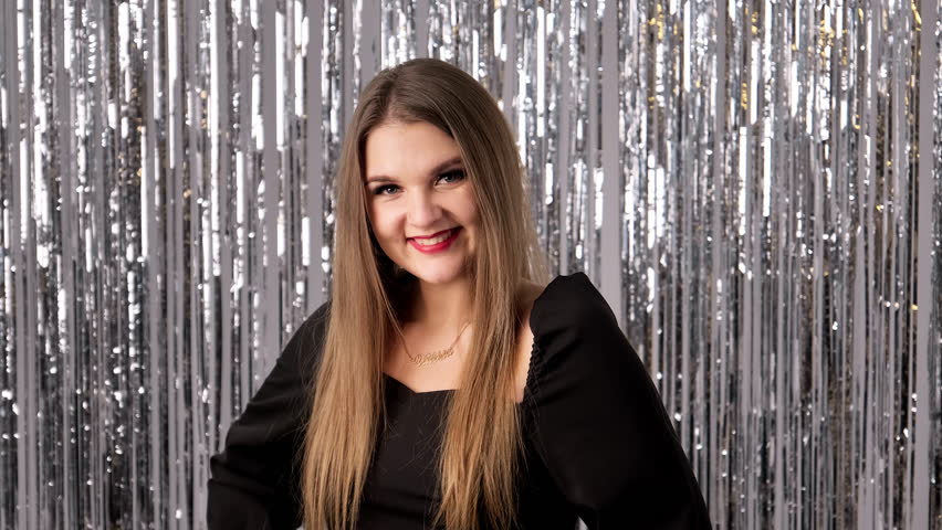 Happy smile on face of charming woman on glittering background. Portrait of elegant woman. Young woman looking at camera. Close-up in 4K, UHD | Shutterstock HD Video #1112056223