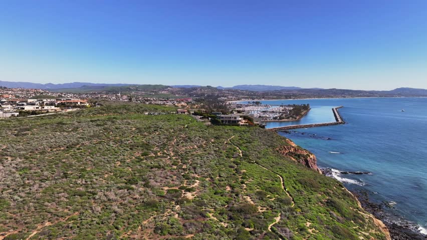 Dana Point Harbor Seen From Dana Point Headlands Conservation Area In California, USA. - aerial shot Royalty-Free Stock Footage #1112060387