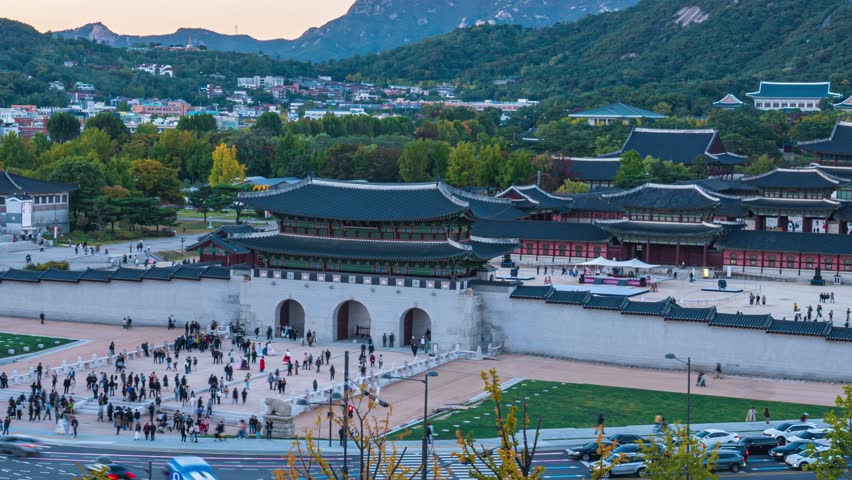 4k time lapse video of Gyeongbokgung Palace and evening traffic after sunset in Seoul. South Korea. zoom out