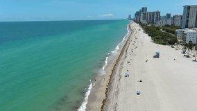Ocean shore, high-rise buildings, sandy beach, ocean. Shooting from a bird's eye view. Shooting from a drone