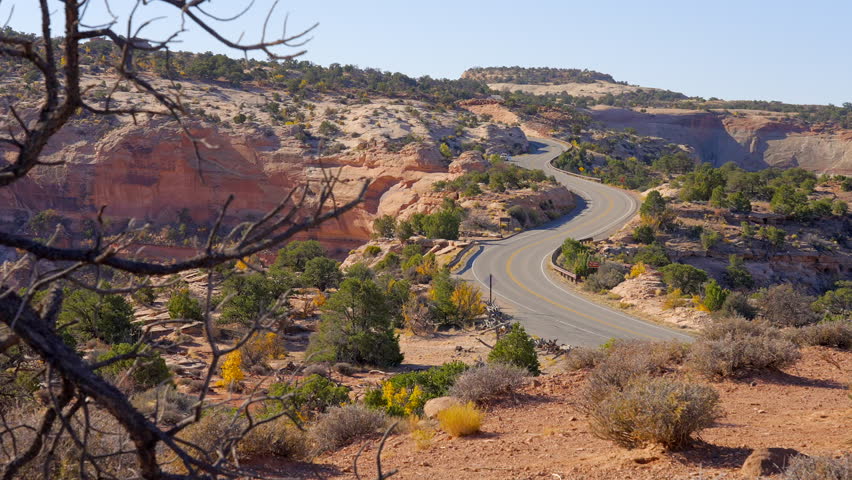 Establishing shot of mountains with red rocks in Shafer Canyon Overlook, Canyonlands National Park, Utah, North America. Day time on October 2023. Still camera view. ProRes 422 HQ.