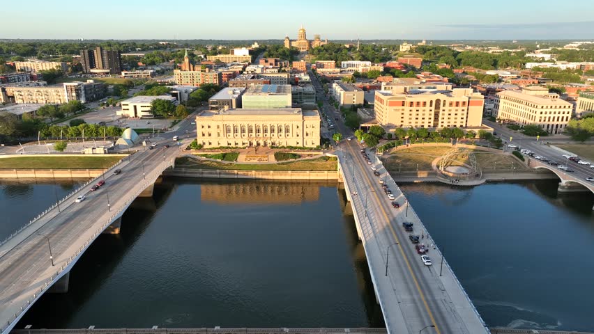Des Moines River and bridges with Iowa Capitol Building at golden hour sunset.