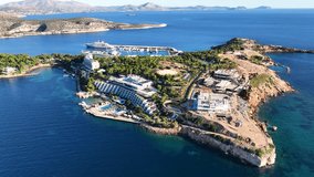 Aerial drone video from famous celebrity sandy beach of Astir or Asteras in south Athens riviera with turquoise clear sea, Vouliagmeni, Greece