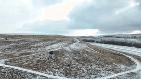 Amazing winter landscape covered  with snow, near the coast, drone flies near the river. 