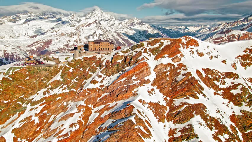 Aerial view of the Gornergrat Observation Platform on a rocky mountain covered with snow in Zermatt. Panoramic view from above the Observation deck in Zermatt, Switzerland during winter time.