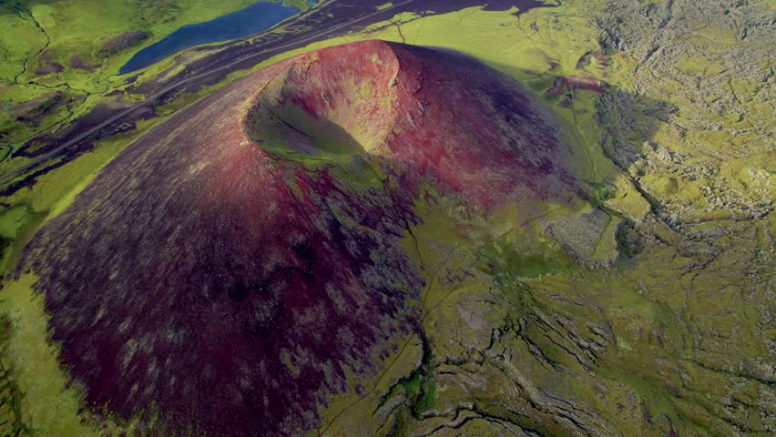 Red Crater in Iceland Landscape Bright Summer Day Aerial. Red Sand Volcano Stands Out of Green Grass Valley Near Road. Drone Close to Crater Looking Down Slow Circle Near Gerduberg. 4K High Quality Royalty-Free Stock Footage #1112083653