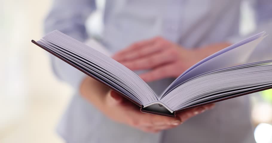 Woman flips through paper book reading useful information for self-development. Assimilation of information in adulthood. Development and erudition Royalty-Free Stock Footage #1112088955