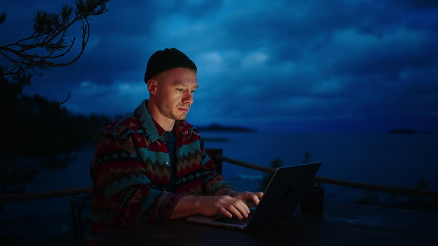 Portrait Of Man Working Remotely With Laptop On Open Terrace With Beautiful View In Night | Shutterstock HD Video #1112089811