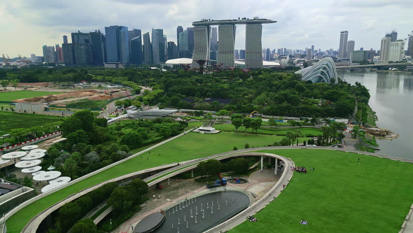 Aerial view flying backwards over the Marina Bay Barrage and skyline of Singapore