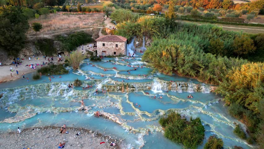 Most famous natural thermal hot spings pools in Tuscany - scenic Terme di Mulino vecchio ( Thermals of Old Windmill) in Grosseto province. Aerial drone 4K hd video Royalty-Free Stock Footage #1112091931
