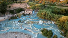 Most famous natural thermal hot spings pools in Tuscany - scenic Terme di Mulino vecchio ( Thermals of Old Windmill) in Grosseto province. Aerial drone 4K hd video