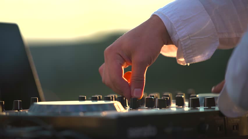 DJ Music. DJ during outdoor festival. modern electrical sound mixer console during concert. Professional sound system dj console.