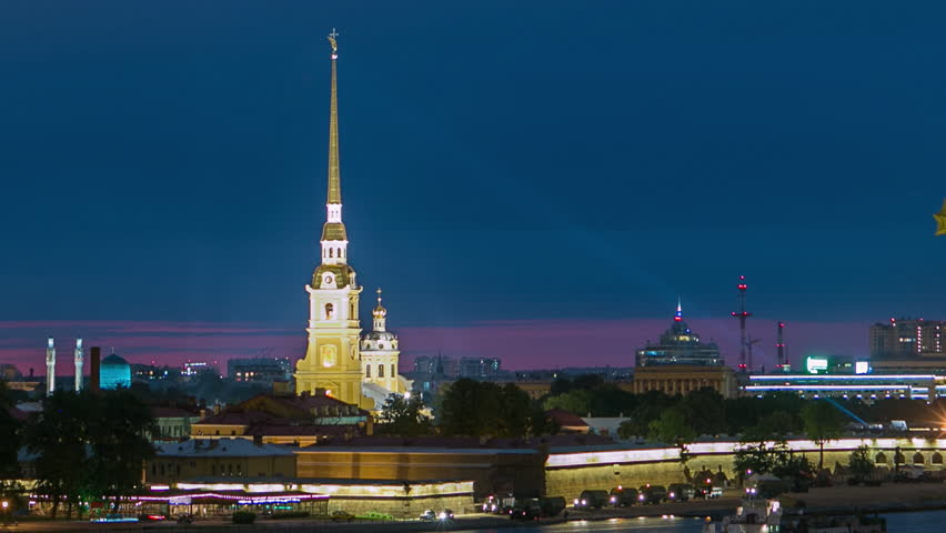 Timelapse showcasing the front view of the iconic Rostral Column, Peter and Paul Cathedral, and the Neva River main attractions of Saint-Petersburg. Captured from a rooftop. Saint-Petersburg, Russia