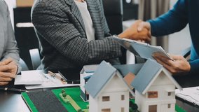 Business meetings of real estate brokers and company presidents to select a model to build a housing estate in writing and presenting to state organizations. - Powered by Shutterstock - Get 15% off with code: PIKWIZARD15