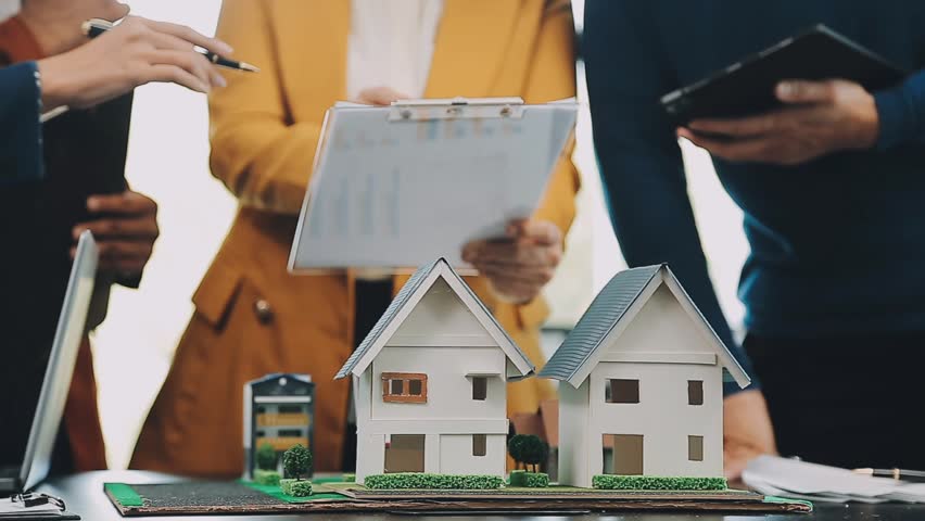 Business meetings of real estate brokers and company presidents to select a model to build a housing estate in writing and presenting to state organizations. Royalty-Free Stock Footage #1112101805