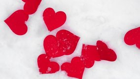 Valentines background. Red hearts falling on natural pure white soft snow surface. Symbol of love in winter holiday season. Romantic outdoor concept for Valentine's day copy space. Top view, close up - Powered by Shutterstock - Get 15% off with code: PIKWIZARD15