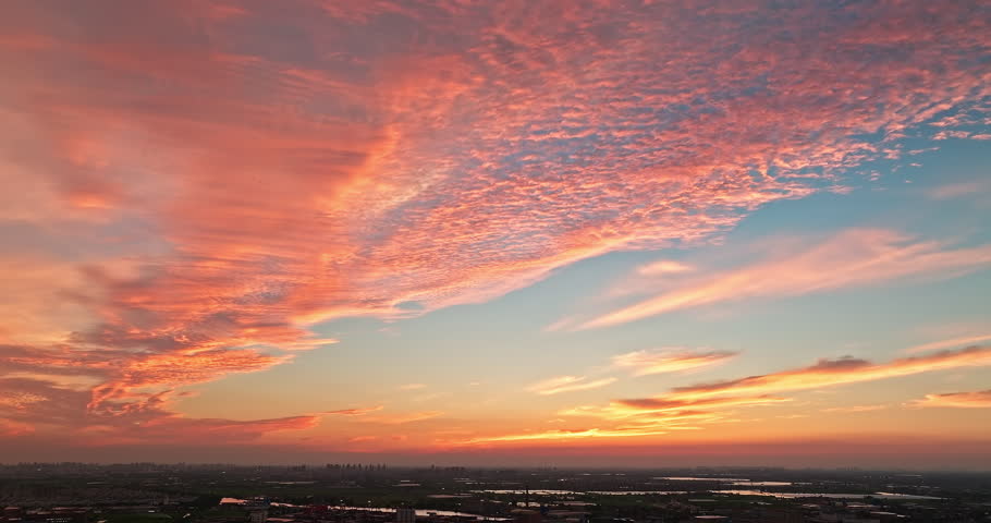 Aerial shot of cloudscape and city skyline at sunset in Shanghai, China